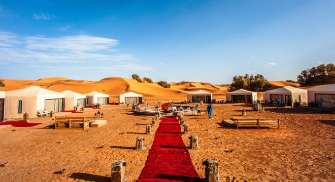 A vibrant desert camp in Merzouga, Morocco on an In-Style small group tour